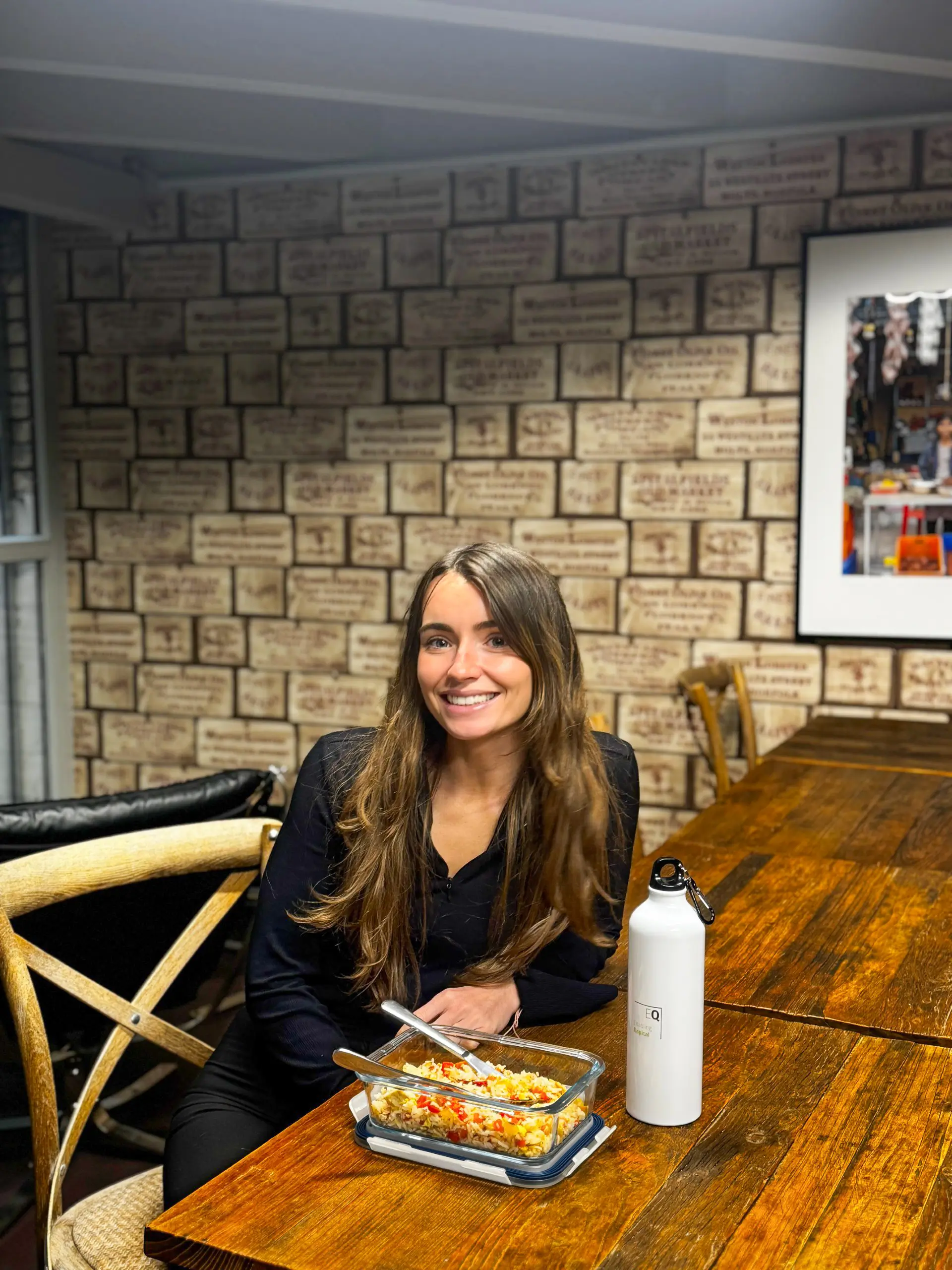 Carla Allen, Junior Business Development Associate at EQ, using a reusable food container provided through the one-time employee allowance